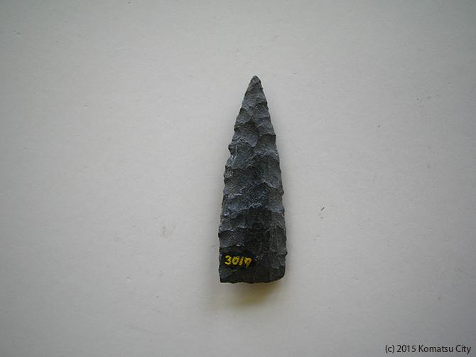 黒で表面がギザギザしていて上部の先端が尖っている打製石鏃 通番号:644の写真